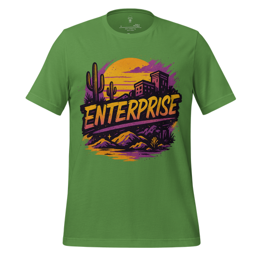 Green Enterprise Graphic T-Shirt by JMK Drip featuring desert landscape with cacti and buildings at sunset