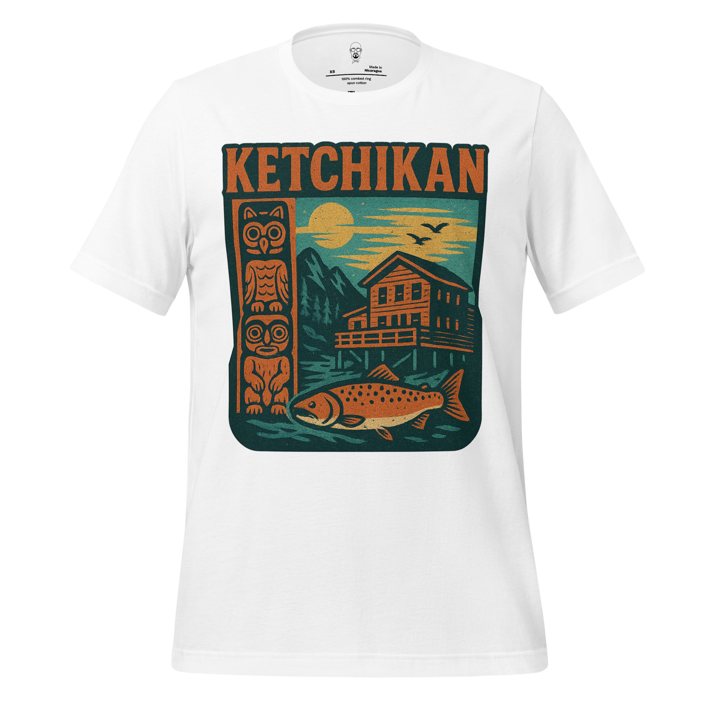 White Ketchikan Graphic T-Shirt featuring totem pole, fish, cabin, mountains, and sunset design